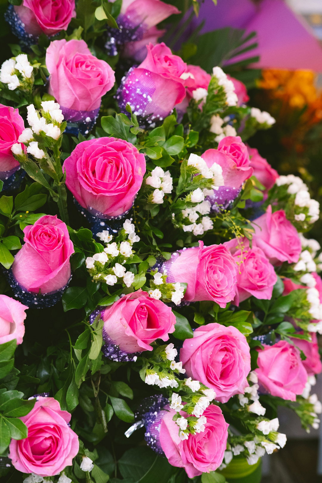 a bouquet of pink roses and white baby's breath